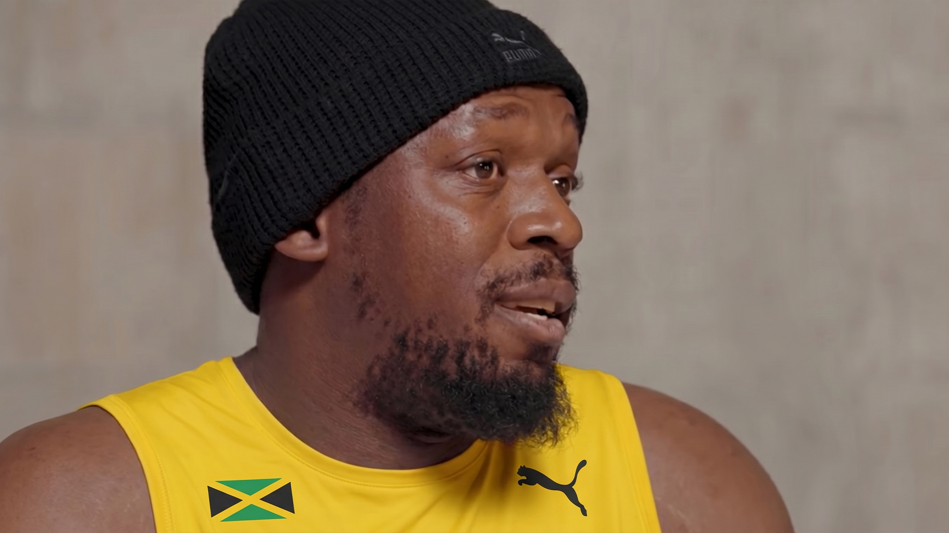 BX99 26/27 Global Brand Ambassador Usain Bolt smiling with a marker, preparing to sign a jersey during a behind-the-scenes shoot