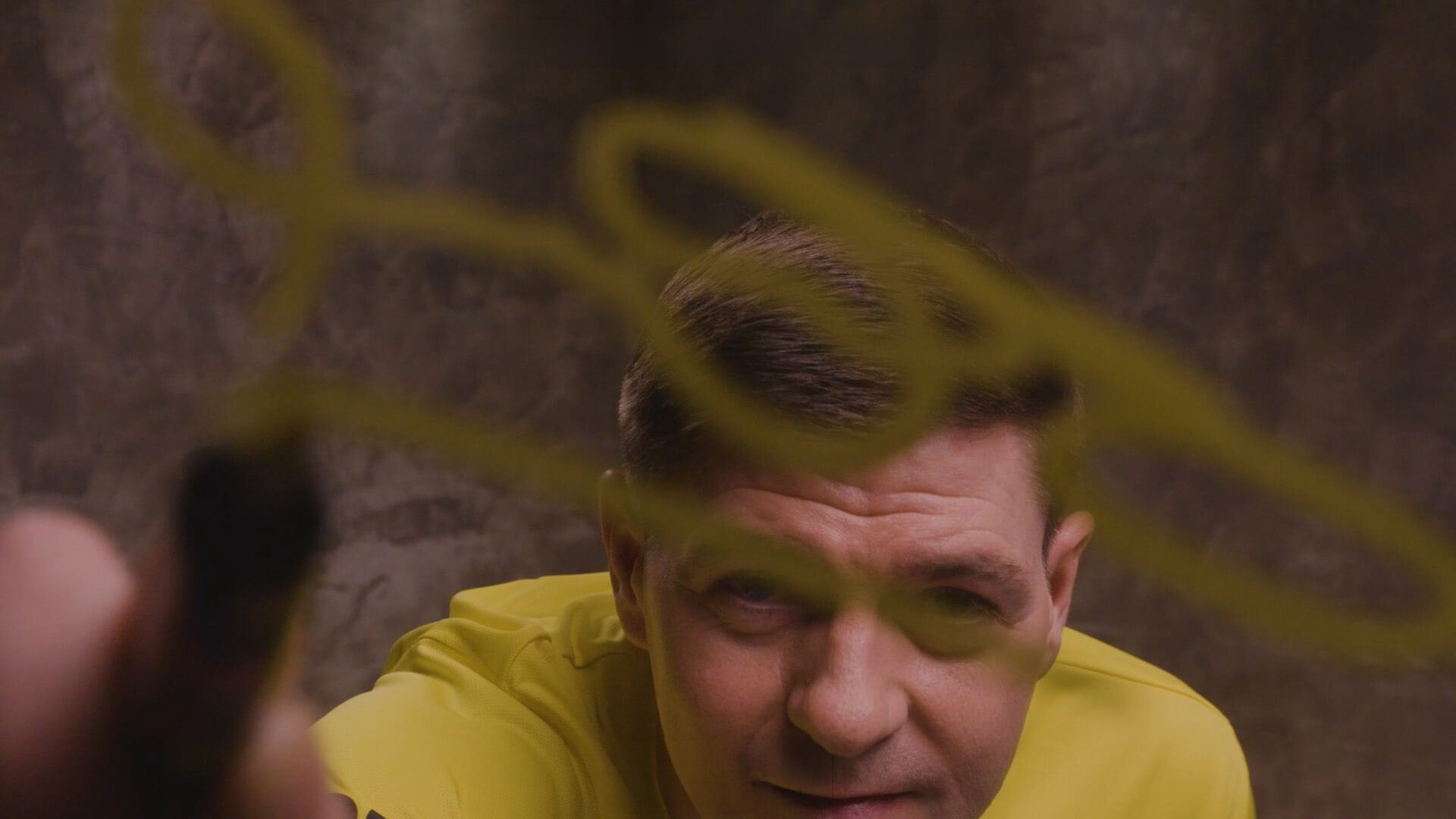 BX99 26/27 Global Brand Ambassador Usain Bolt signing his autograph on a glass screen during a creative behind-the-scenes shoot
